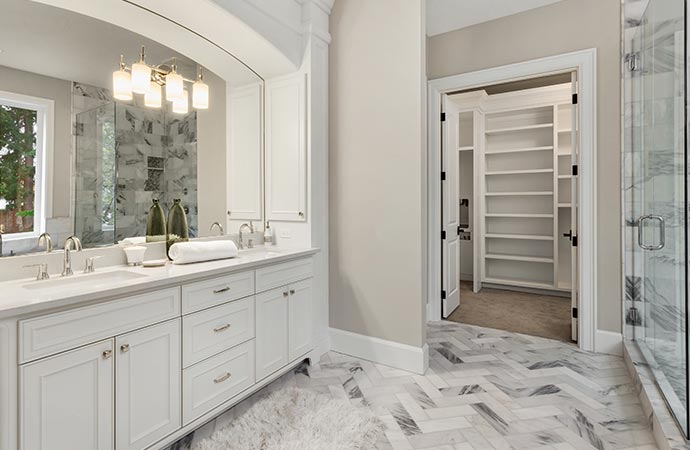 luxury master bathroom with double vanity of walk in master closet